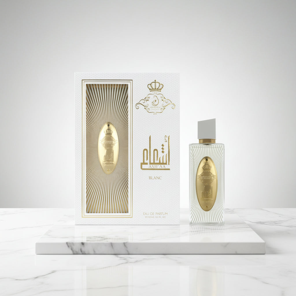 A bottle and box of ARABIYAT PRESTIGE - ASHA'A BLANC 3.7FL.OZ EDP SPRAY for women and men, featuring a white box with gold accents and emblem, and a clear bottle with gold label, silver cap, and fresh green tea notes.