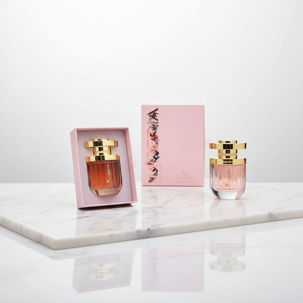 Perfume bottle with gold cap and pink packaging on a white background