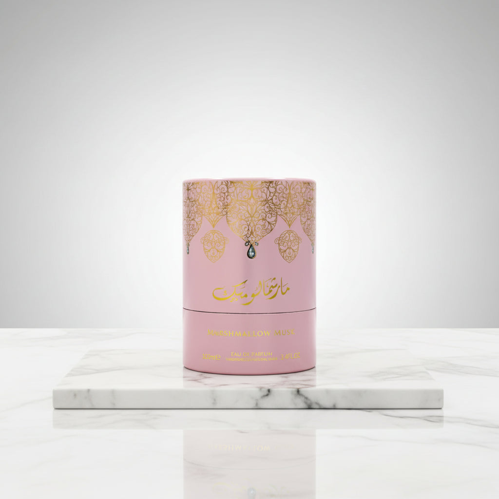 Pink and gold perfume bottle with decorative design on a white background