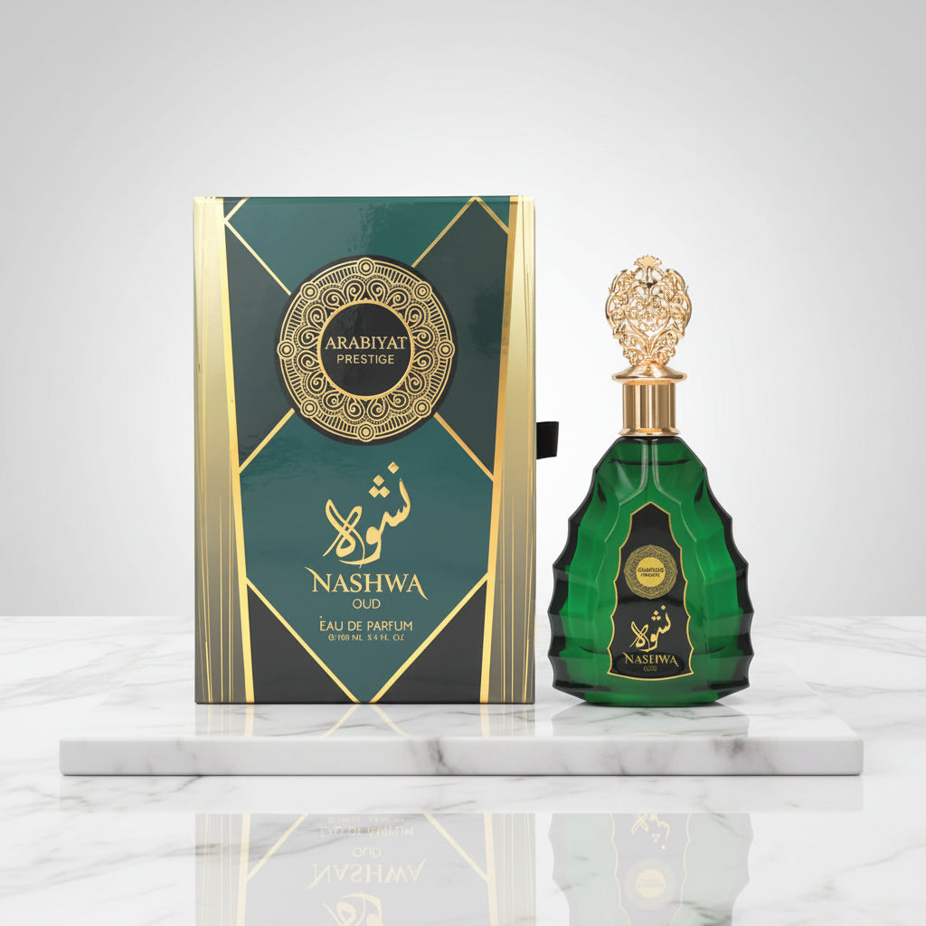 Green perfume bottle with gold cap and 'Nashwa' branding next to its packaging on a white background.