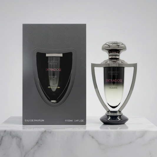 Perfume bottle and packaging of 'Extradose' on a marble surface with a light gray background