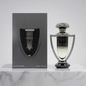 Perfume bottle and packaging of 'Extradose' on a marble surface with a light gray background