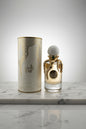 Perfume bottle with gold cap and decorative label on a white background